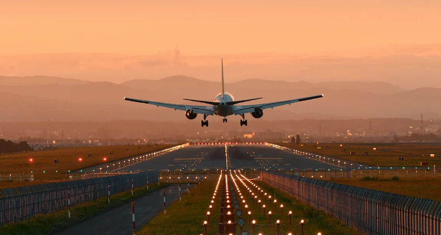 airplane landing in an orange sunset