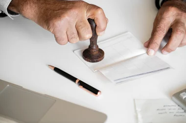 hands stamping a document