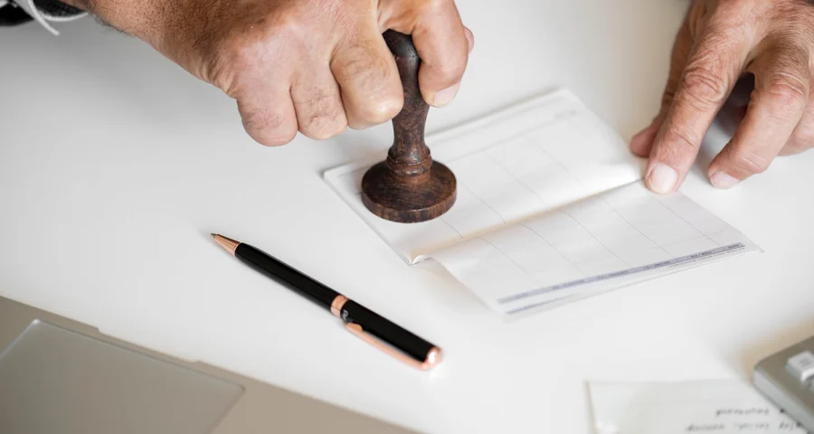 hands stamping a document