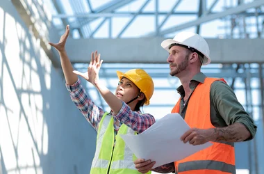 Young man and woman inspecting new buildings.