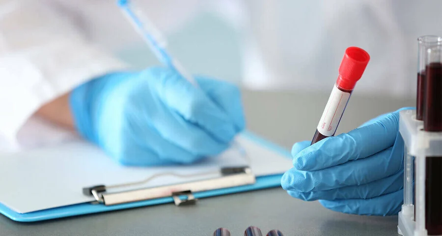 medical technician recording blood titer results