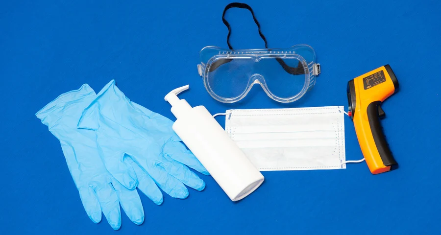 latex gloves, sanitizer, goggles, mask, and thermometer
