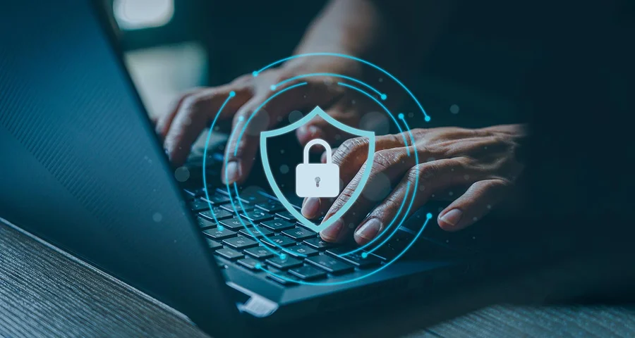 Person working on a computer with cybersecurity