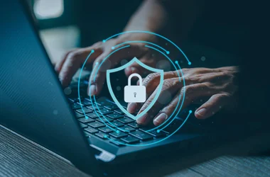 Person working on a computer with cybersecurity
