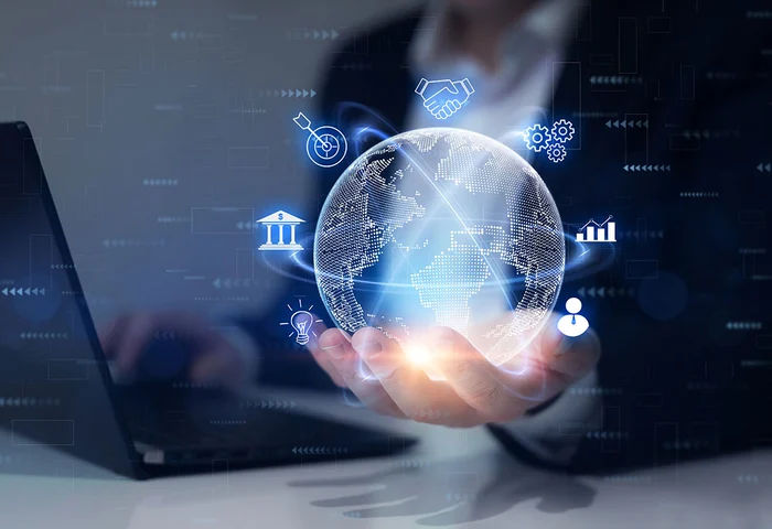 businessman holding digital illustration of globe with partnership related icons