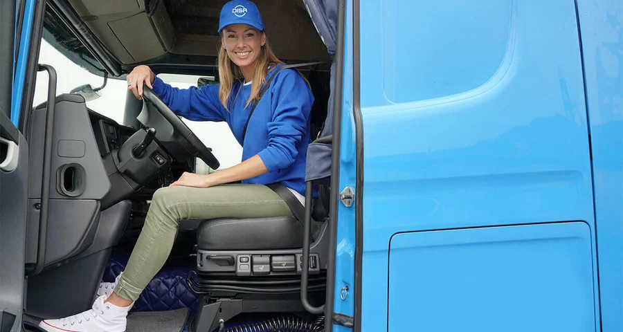 Female truck driver sitting in an 18-wheeler