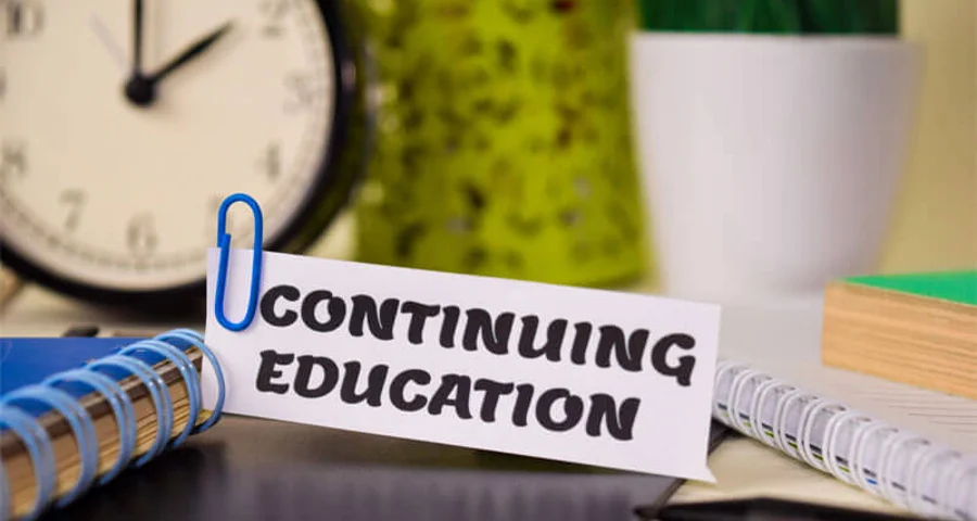Continuing Education on piece of paper on a desk