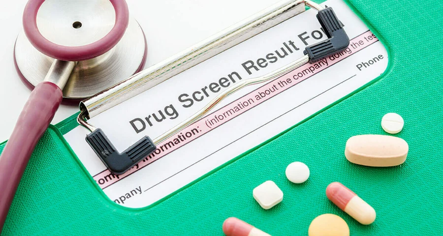 drug test results on a clipboard with pills