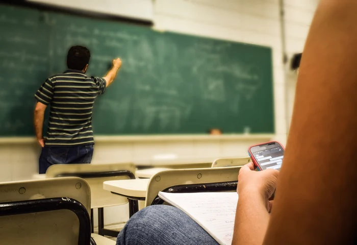 teacher writing on a blackboard