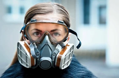 Worker practicing safety by wearing a respirator mask