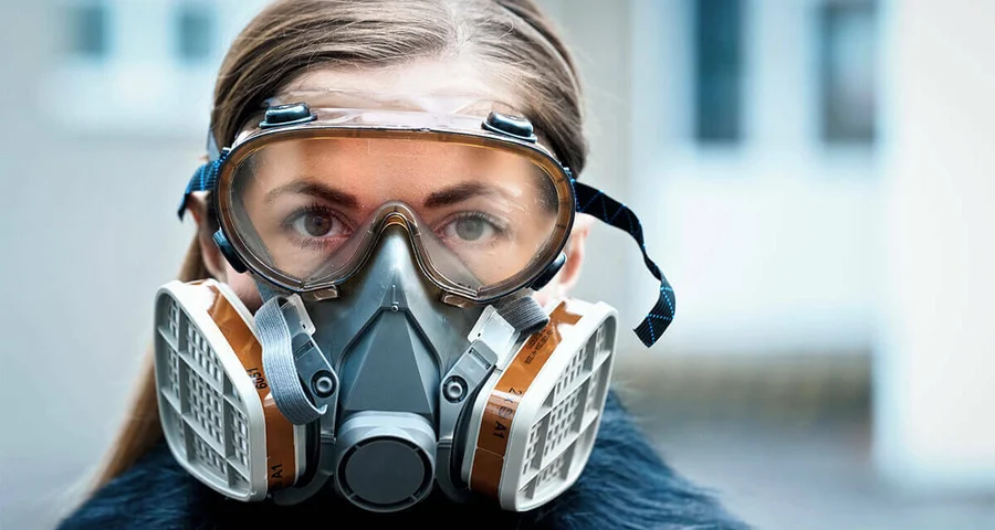 Worker practicing safety by wearing a respirator mask
