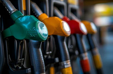 Close-up of colorful fuel pump nozzles at a gas station, in a row with different colors indicating various types of fuel. Fuel Tax Recovery