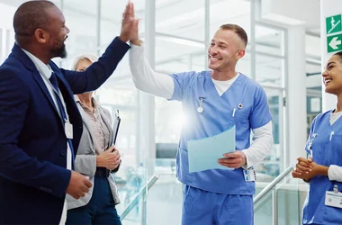 healthcare staff high fiving celebrating at hospital