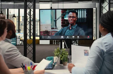 Recruiters conducting an online video interview with a candidate to evaluate employment history