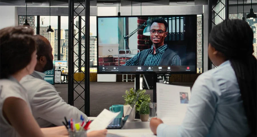 Recruiters conducting an online video interview with a candidate to evaluate employment history