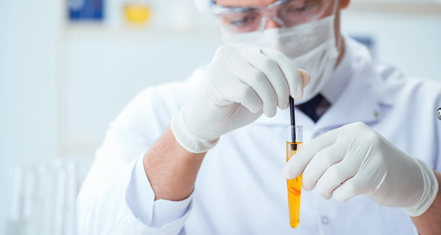Lab technician performing a drug test in a test tube