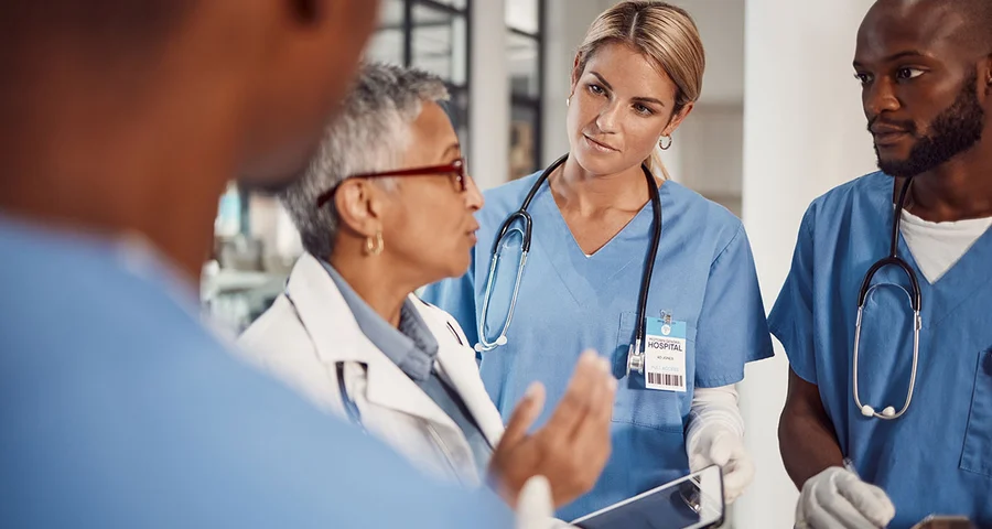 Nurses in hospital listening to doctor