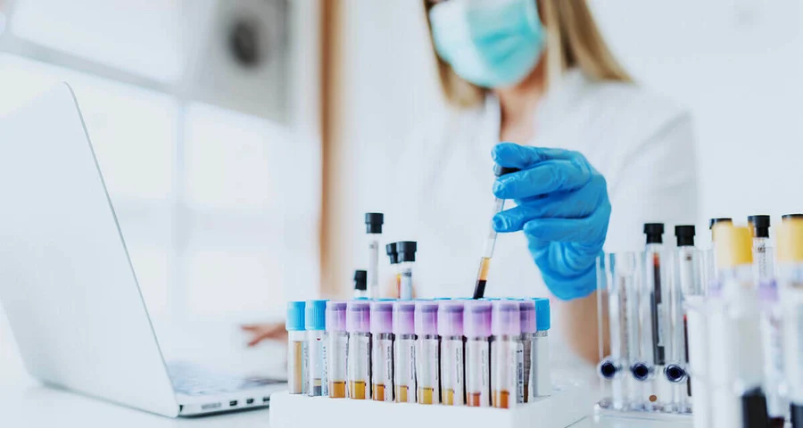 medical technician performing random drug testing in a lab