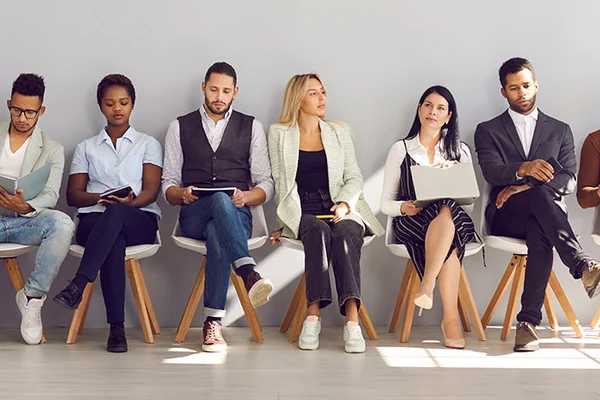 job applicants sitting in a row waiting for interview