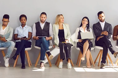 job applicants sitting in a row waiting for interview