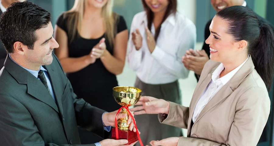 Background check award being presented between professional business people