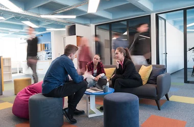 A group of employees sitting and having a discussion