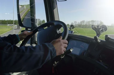 closeup photo of a man driving a large vehicle