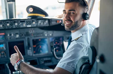 male posing at the camera in cabin of passenger aircraft