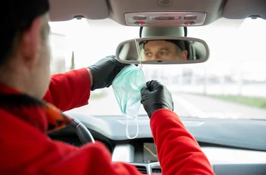 truck driver reaching for face mask