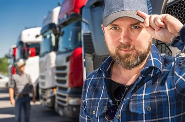 DOT employee standing in front of several trucks saying goodbye
