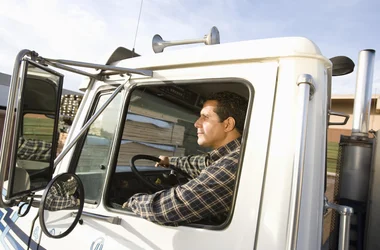 Truck driver driving with the window down