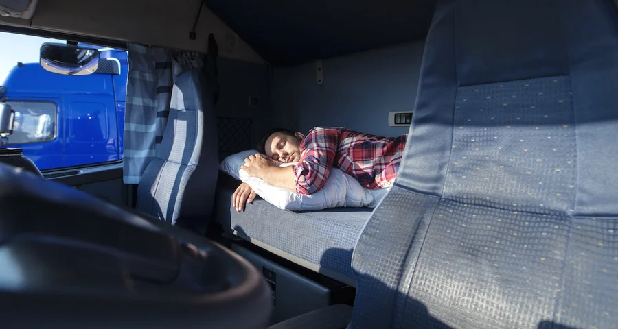 Truck Driver taking a rest break in his sleeping compartment