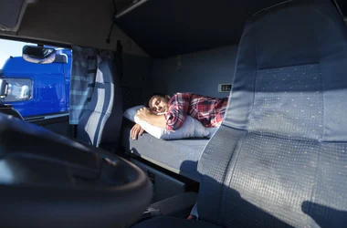 Truck Driver taking a rest break in his sleeping compartment