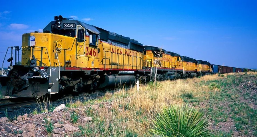 Train traveling through a field