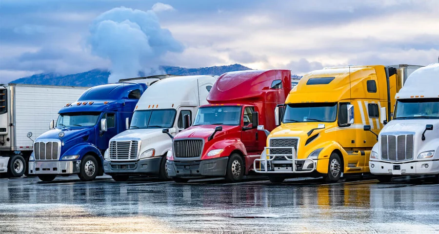 several trucks parked and lined up in a row