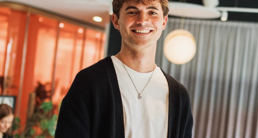 Smiling male employee holding notebook