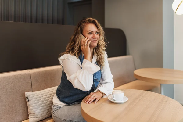 woman talking on her cell phone in a cafe