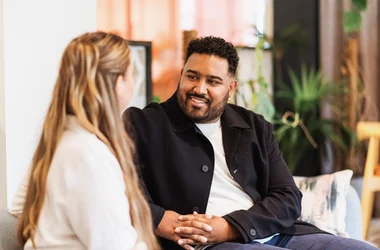 Two DISA employees sitting in a room and talking