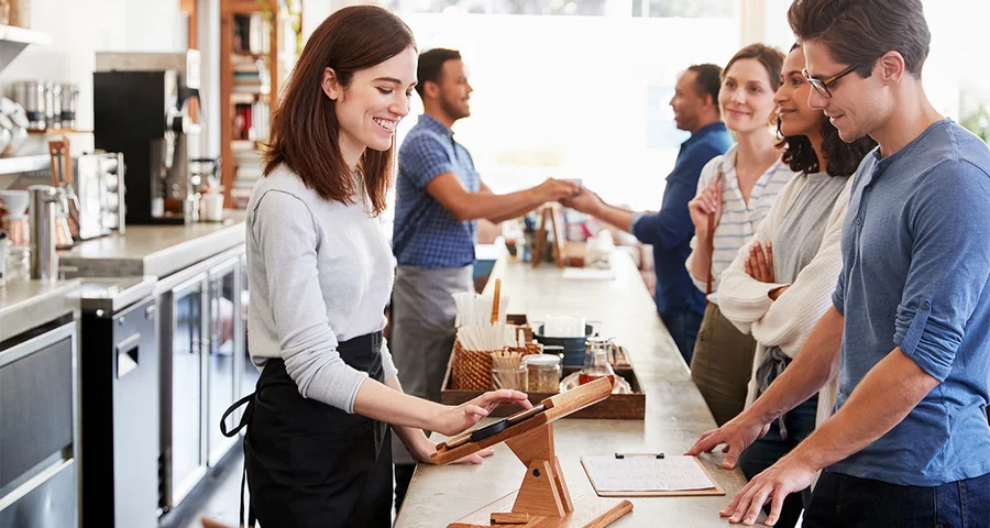 Restaurant employee taking an order from a customer