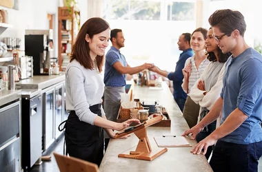 Restaurant employee taking an order from a customer