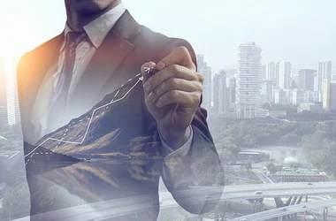 company growth businessman pointing at chart