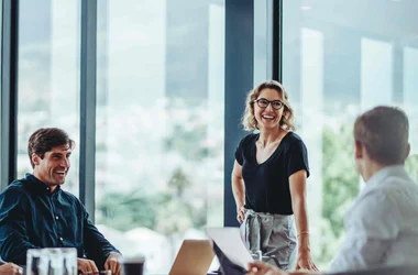 People meeting in board room and smiling