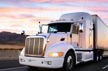 truck driving in sunset