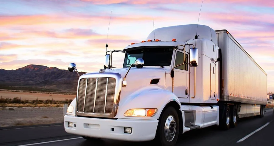 truck driving in sunset