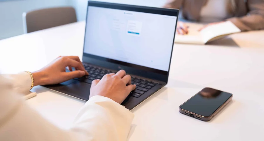 Close up of someone typing on their laptop