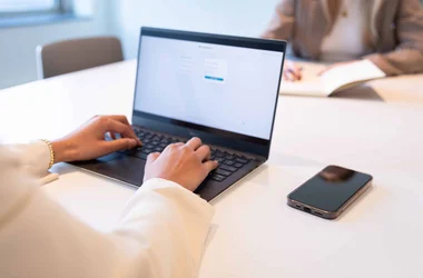 Close up of someone typing on their laptop