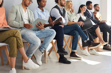 job applicants sitting waiting in line for interviews