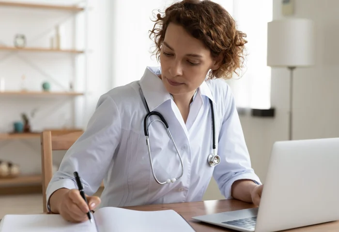 doctor taking notes at her desk