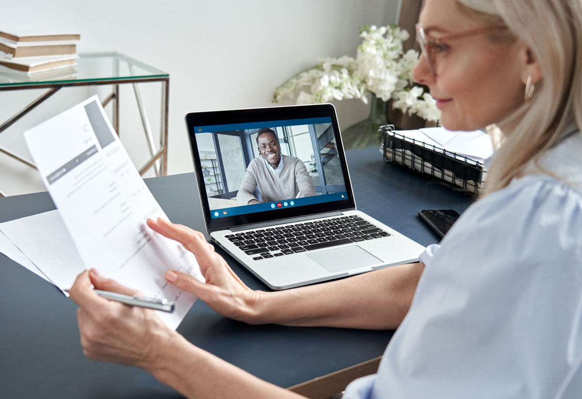 HR rep reviewing a candidate resume while on a virtual interview