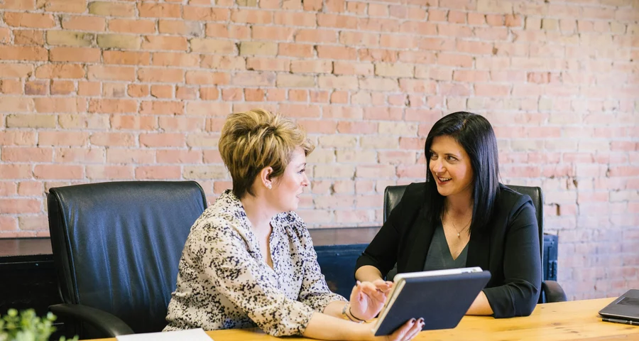 Two female employers discuss background checks in Gothenburg.